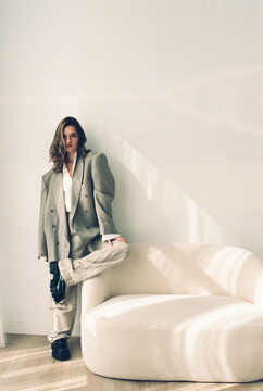 Film photography of young woman posing in a gray suit