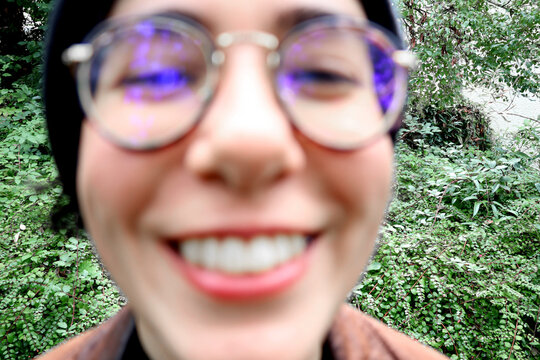 Wide angle close-up portrait of a smiling woman