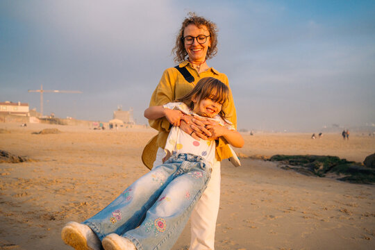 Swinging child by the beach in warm light