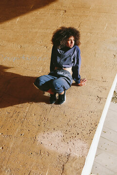 Woman sitting on ledge