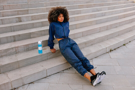 Woman resting on stairs