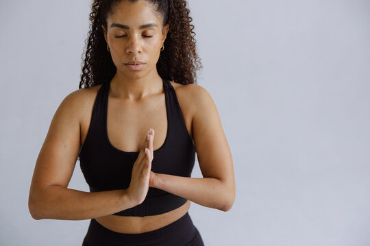 Focused Woman Practicing Meditation with Hands in Prayer Pose
