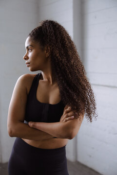 Confident Woman Posing in Athletic Attire in Bright Studio Setting