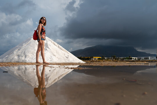A woman visiting a salt mine on a sunny day