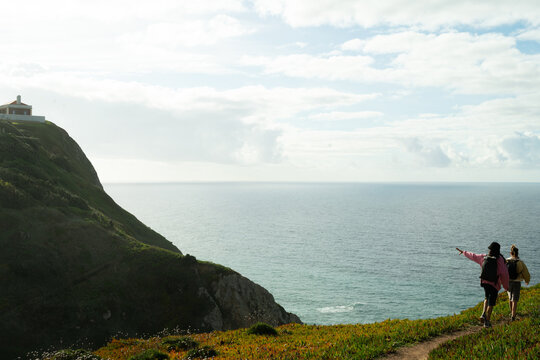 A colourful couple walking down to lighthouse beach