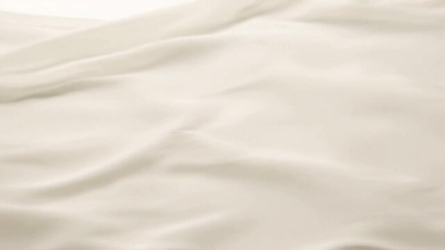 Monochromatic Fabric Blur A single piece of fabric in a neutral tone, moving to create soft, blurred lines and shapes with long exposure.