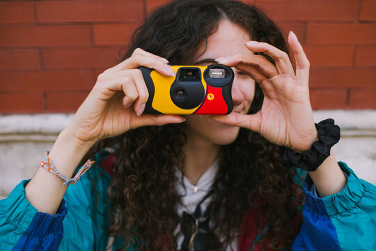 Woman aiming disposable camera