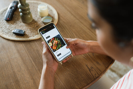 A woman orders food from a mobile phone