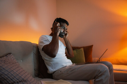 A man uses a laptop at home