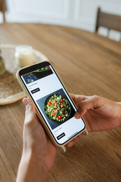 A woman orders food from a mobile phone