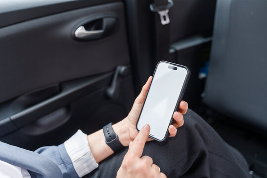 Businesswoman using smartphone with blank white screen 