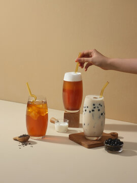 Various bubble teas are presented with ice and ingredients.