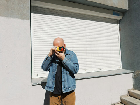 Person holding a disposable camera 