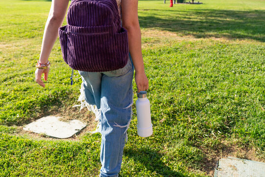 student walking water bottle