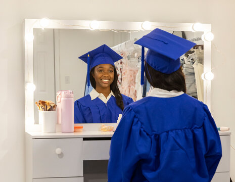 Black Teen graduation reflection look in mirror 