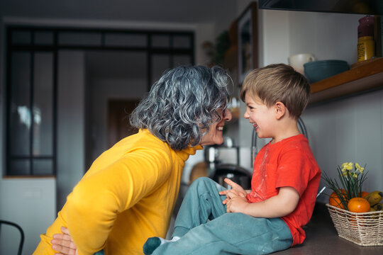 Grandmother and grandson sharing a loving moment in the kitchen