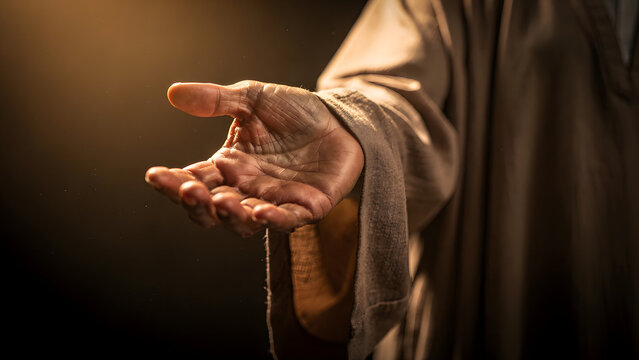 Jesus Christ Extending Hand in Dramatic Light