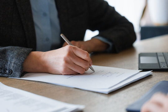 The woman fills out the documents