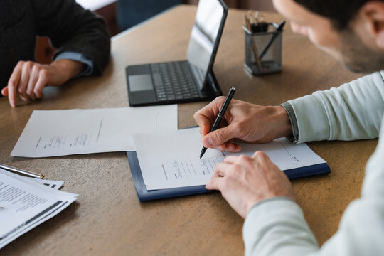 The man fills out the documents