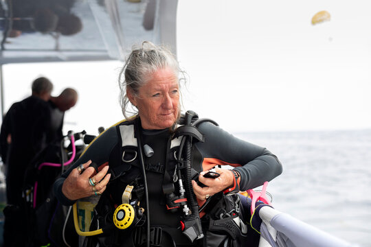 Scuba Diver Preparing for Underwater Exploration on the Boat