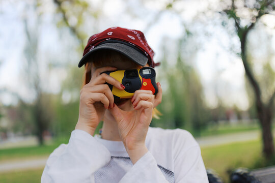 Young woman captures moments with a disposable  camera 