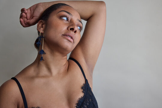 Woman posing in lace top and earrings