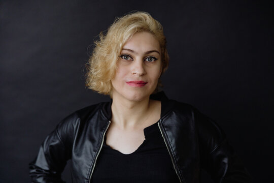 Confident Woman With Blond Hair Wearing a Leather Jacket