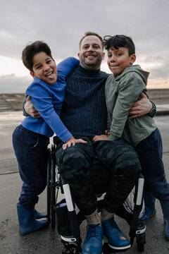 Happy Father Bonding Outdoors with Two Joyful Sons