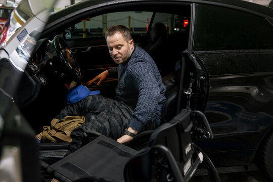 Man Transferring From Vehicle to Wheelchair in Garage Setting