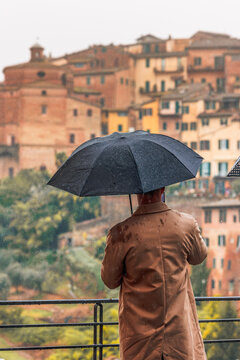Man with Umbrella in Rainy Siena View