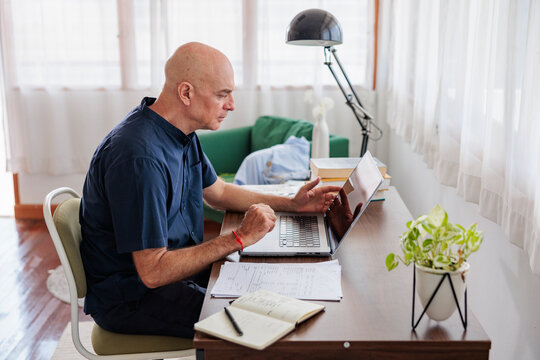 Grandfather writing email on laptop