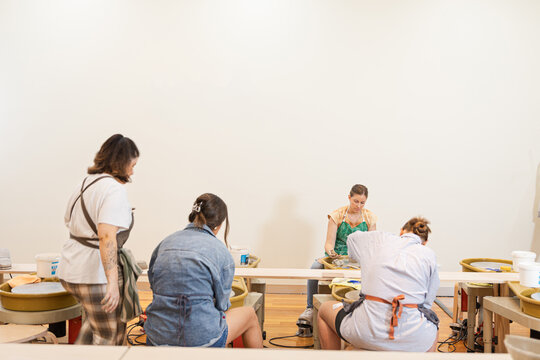 Group pottery session with friends engaged