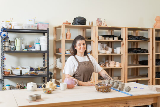 Female potter at the studio with clay and tools in Australia