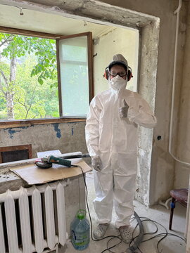 Renovation worker in protective white suit