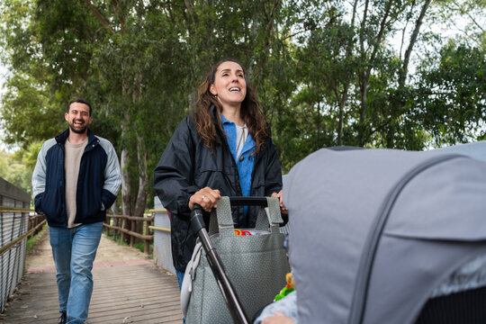 Parents walking with baby stroller