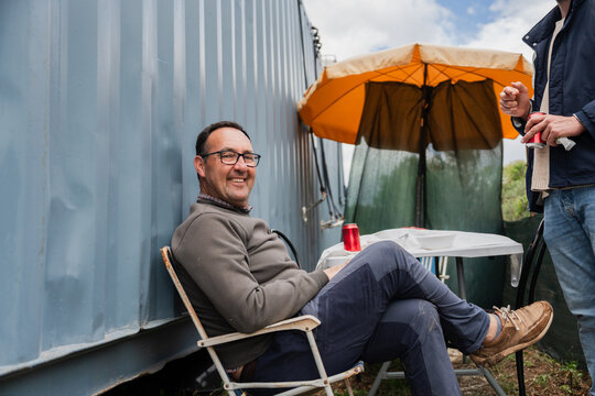 Man sitting on a chair relaxing with a drink
