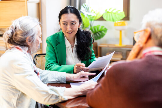 Financial advisor meeting with senior couple at cozy office