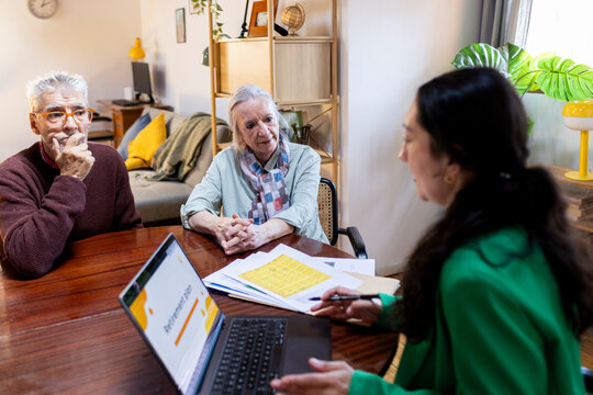 Senior couple meeting with financial advisor at home 