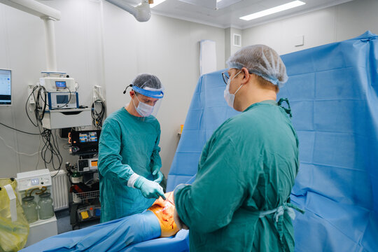 Two surgeons performing operation in hospital