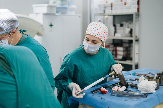 A nurse assists during surgery