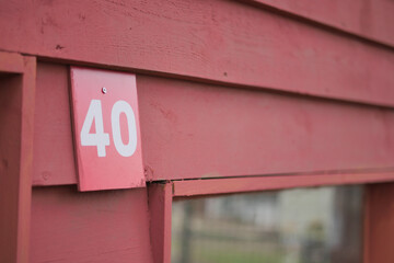 House number 40 on a red wooden wall