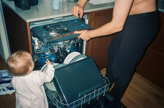 Toddler at Open Dishwasher Helping Dad With Domestic Chores - film