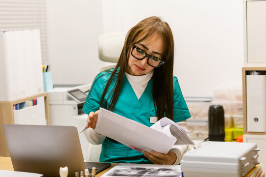 Doctor  Reviewing Patient Documents