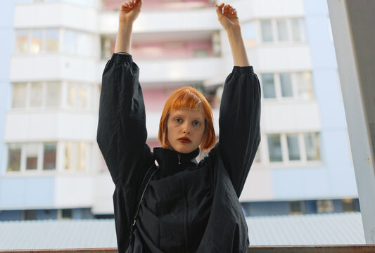 Title

Young Woman With Outstretched Arms Against Urban Building