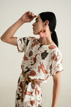 person in patterned satin outfit 