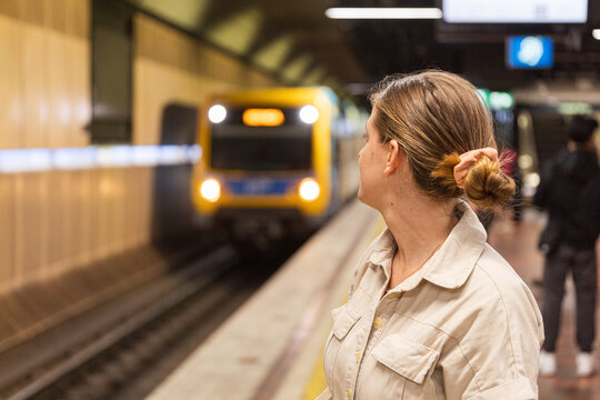 Woman Waiting for Train at Urban Subway Station in Melbourne
