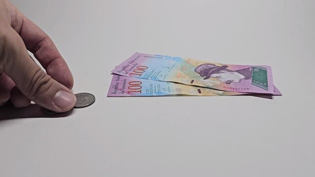 Currency Value Contrast Between Venezuelan Bol&iacute;var and US Dollar. Two hundred Venezuelan Bolivars Equal Fifty US Cents &ndash; Currency Exchange Concept