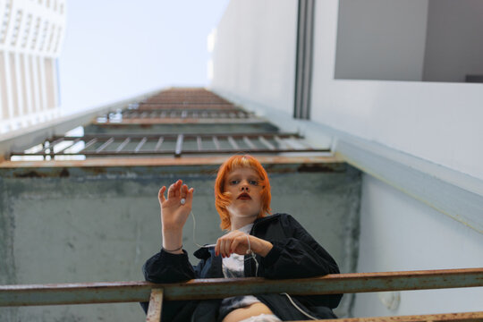 Urban Portrait of a Young Person with Red Hair and Contemporary Outfit