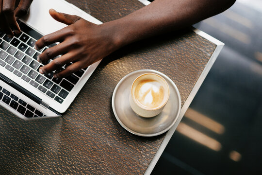 Working with Coffee and Laptop in Caf&eacute; Setting