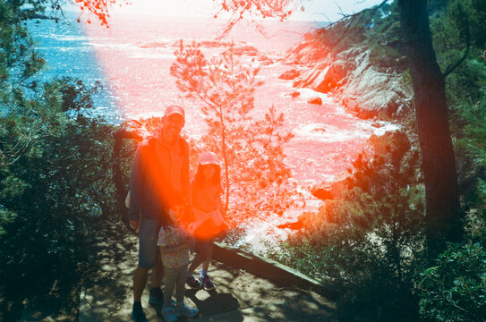Family Hiking Adventure Coast Trail. Sunflare film artifact